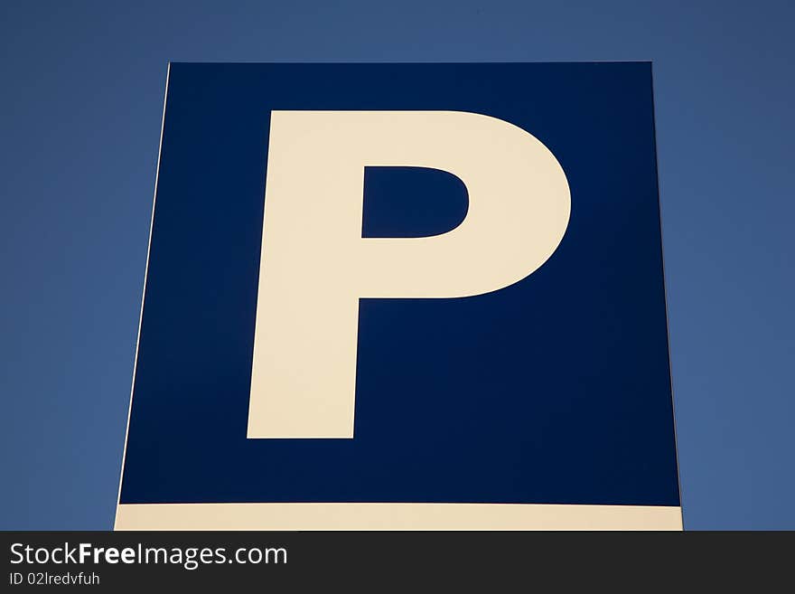 Close-up of parking sign against blue sky background. Close-up of parking sign against blue sky background