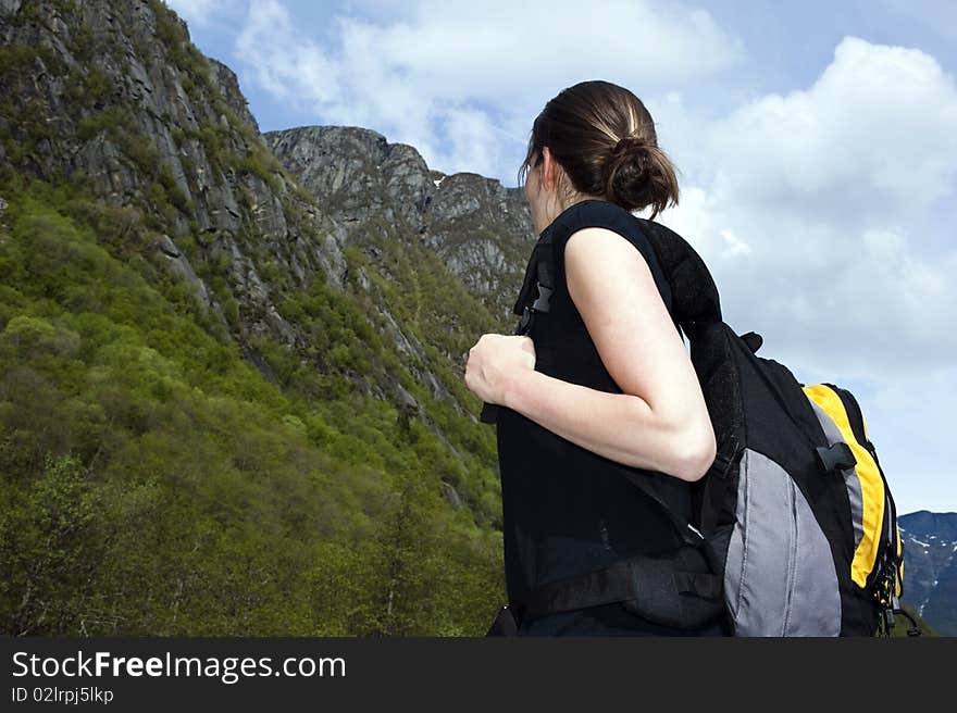 Woman hiker looks to the mountain. Woman hiker looks to the mountain