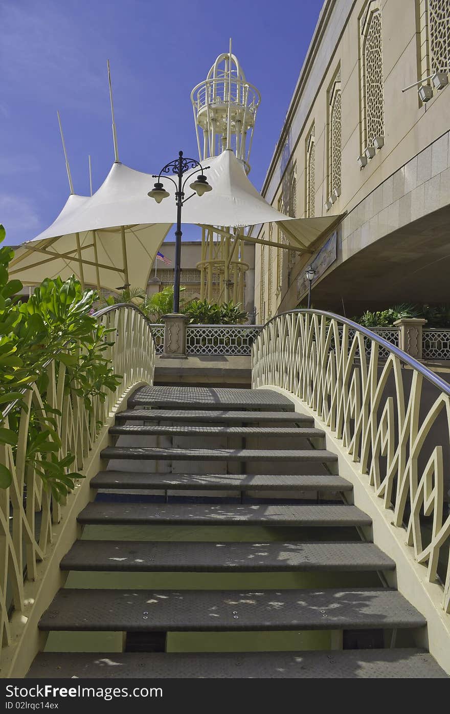 Arch Bridge made of decorative metal or steel steps and railing next to decorative concrete bridge and white canopy. Arch Bridge made of decorative metal or steel steps and railing next to decorative concrete bridge and white canopy