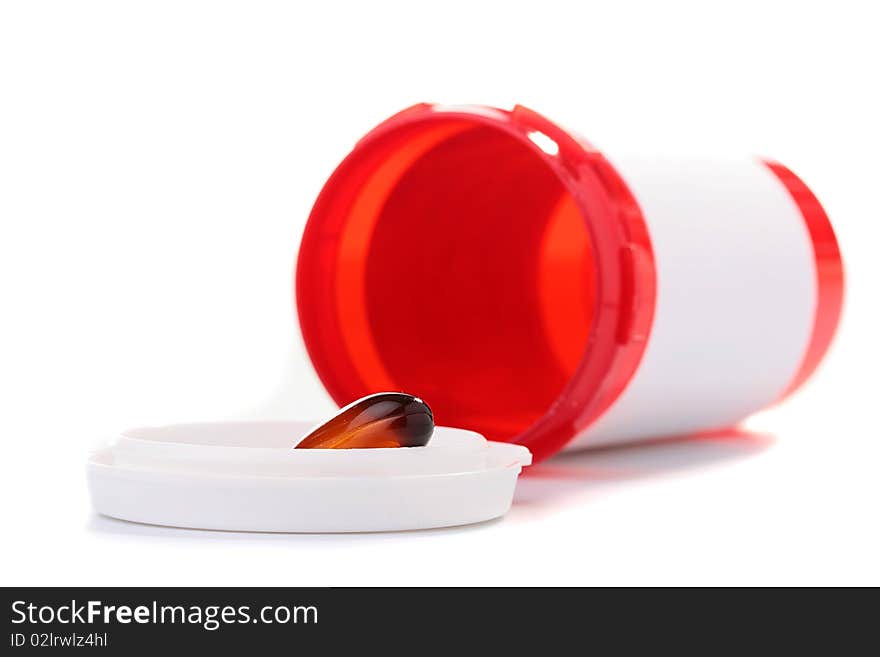 Tablet of brown colour in a cover of the empty container for medicines.