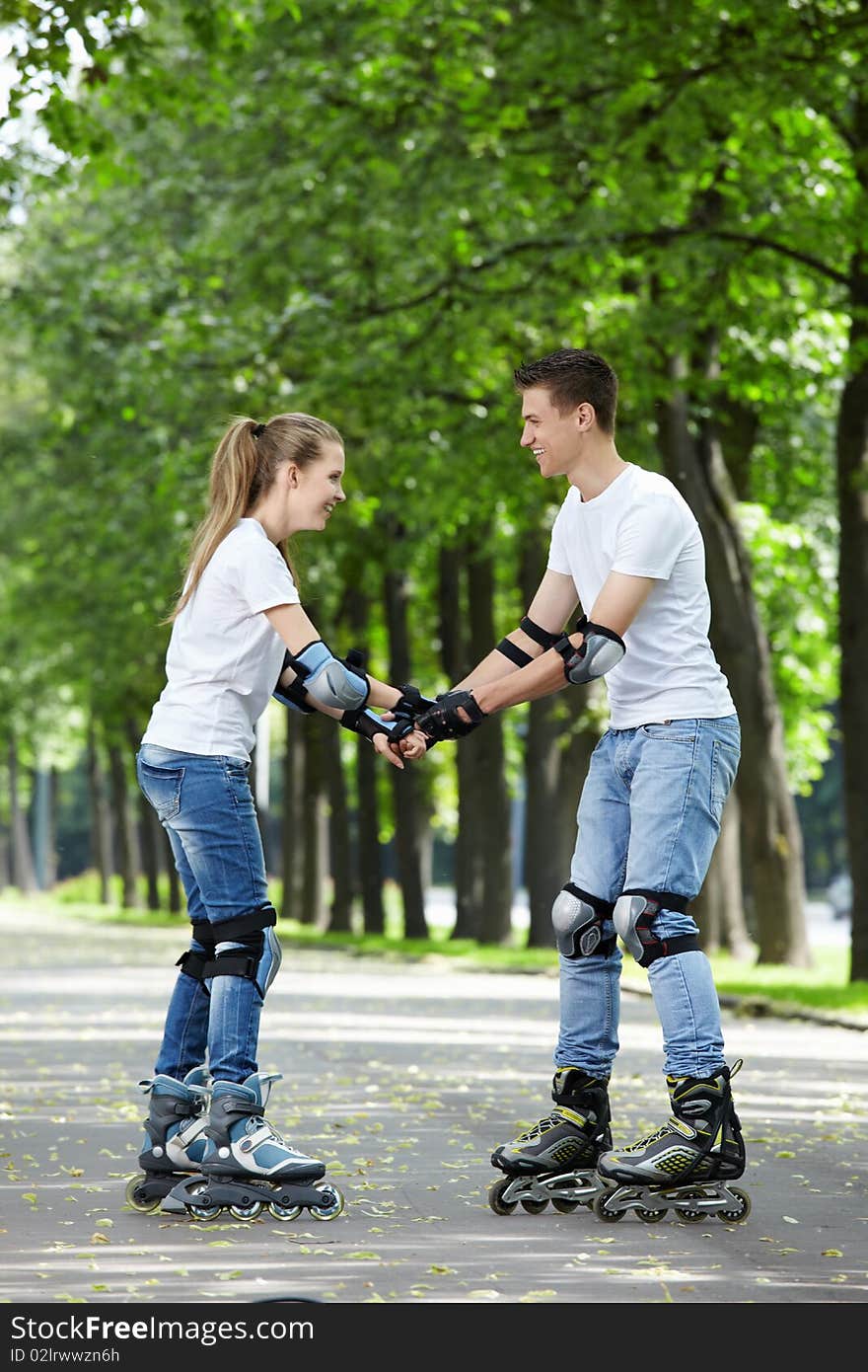 The young couple goes for a drive on rollers. The young couple goes for a drive on rollers