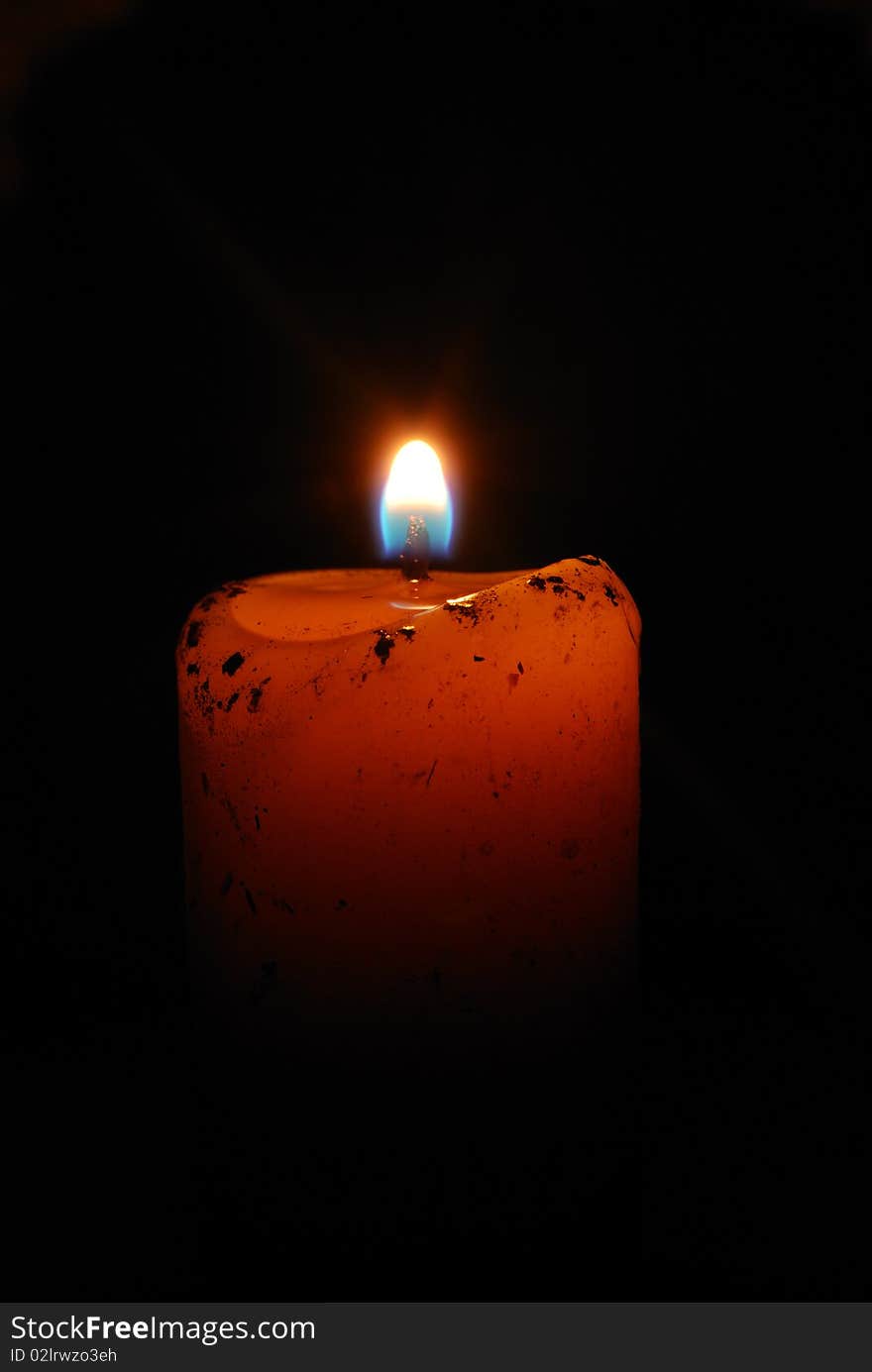 Burning candles on a dark background with warm light