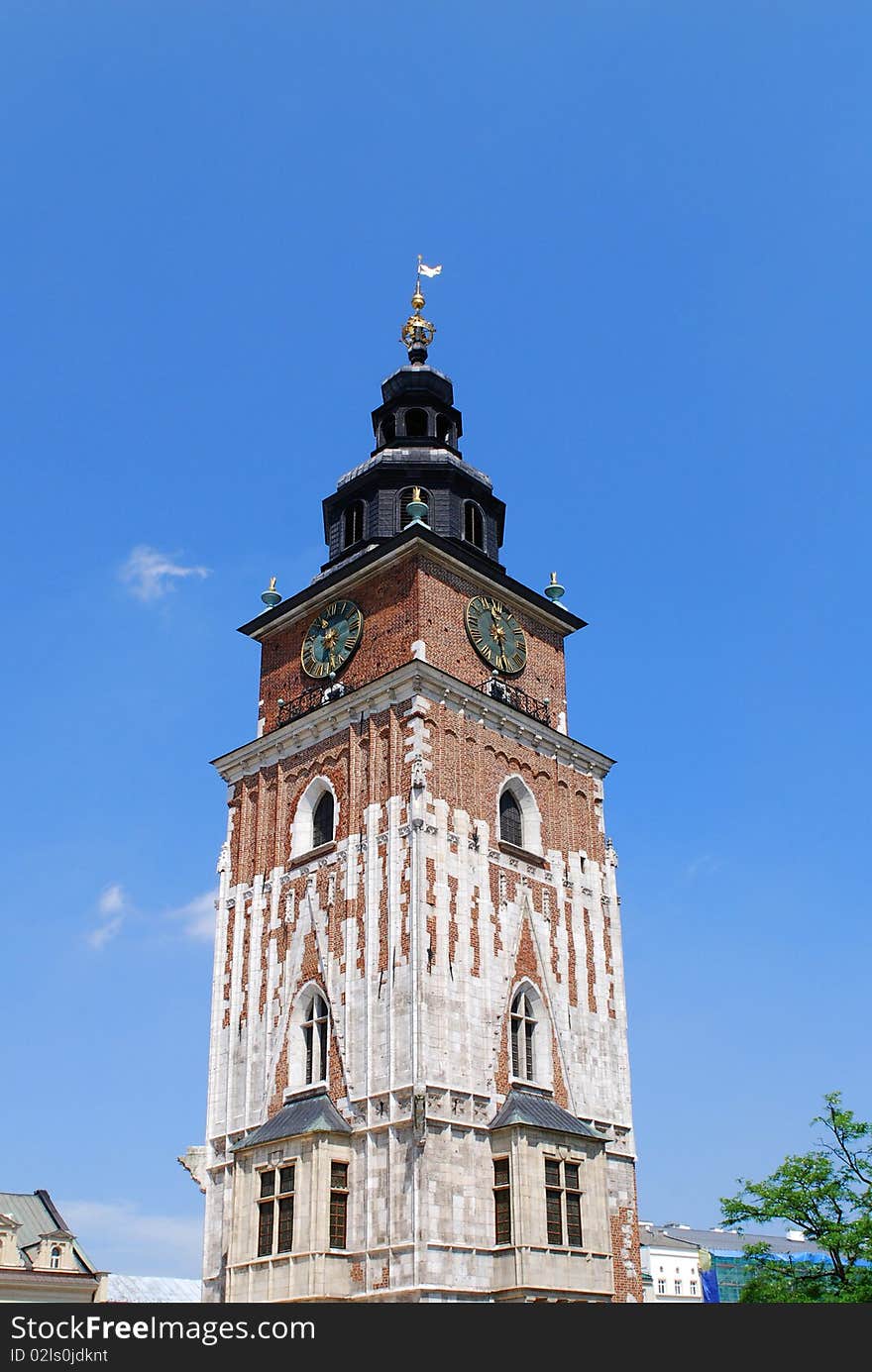 Town hall with clock in summer Krakow