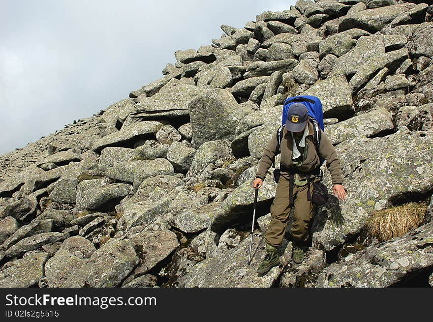 A backpacker trekking in the sea of rocks. A backpacker trekking in the sea of rocks