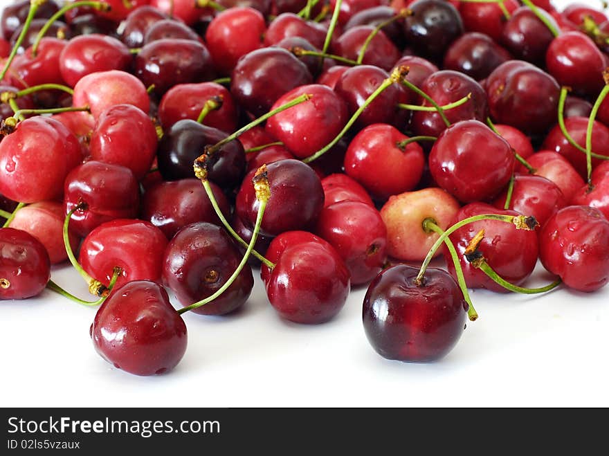 Scattered seen cherries on the white background. Scattered seen cherries on the white background