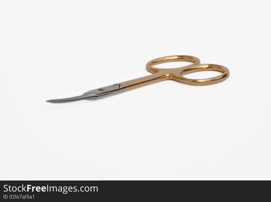 Manicure scissors lying on a white background