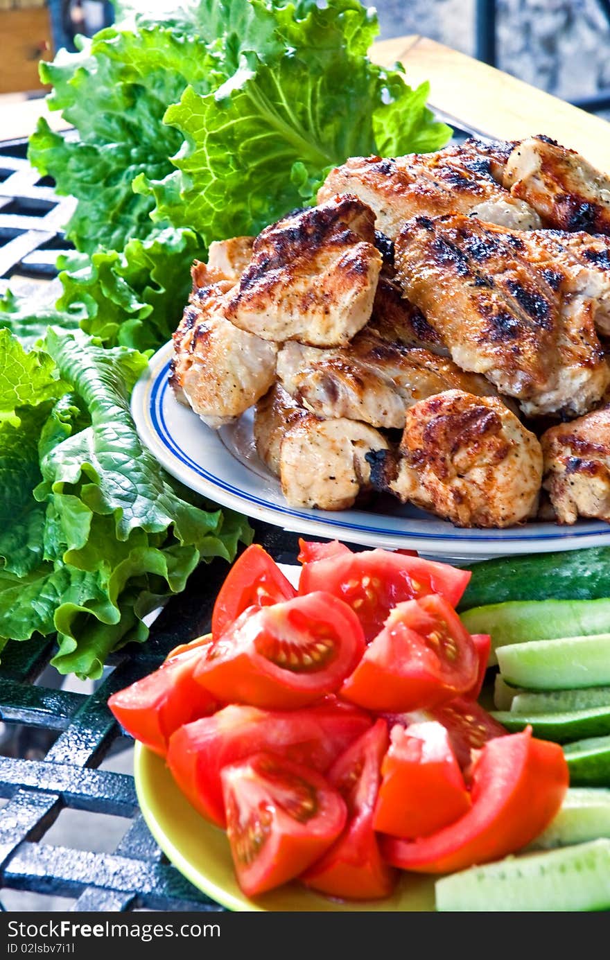 Grilled meat with vegetables on table. Grilled meat with vegetables on table