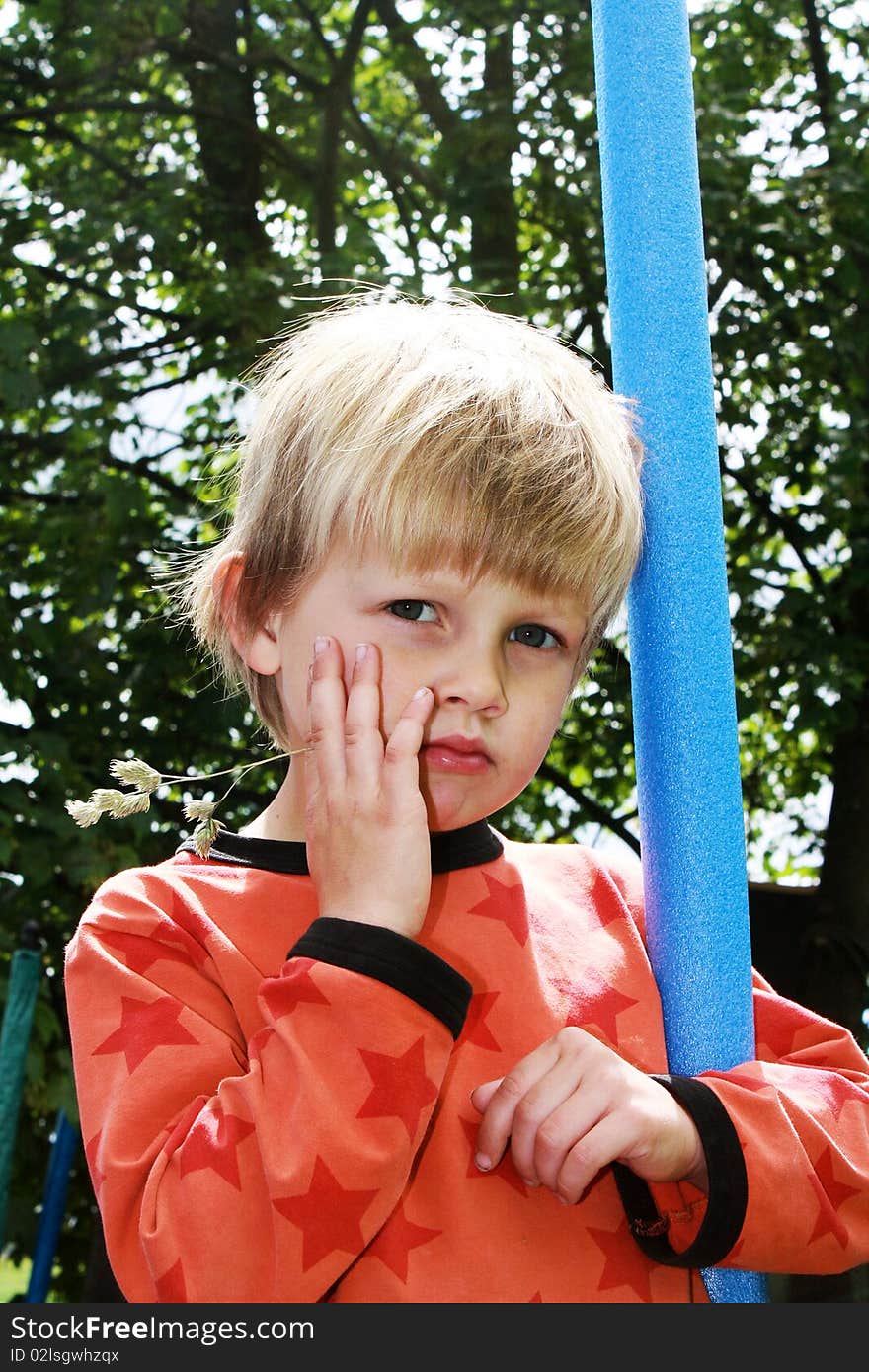 Tough Boy standing with a straw in his mouth. Tough Boy standing with a straw in his mouth