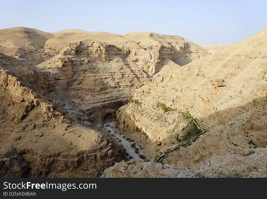 Evening view on wadi Qelt - huge ravine in Judea Desert, Israel. Evening view on wadi Qelt - huge ravine in Judea Desert, Israel.