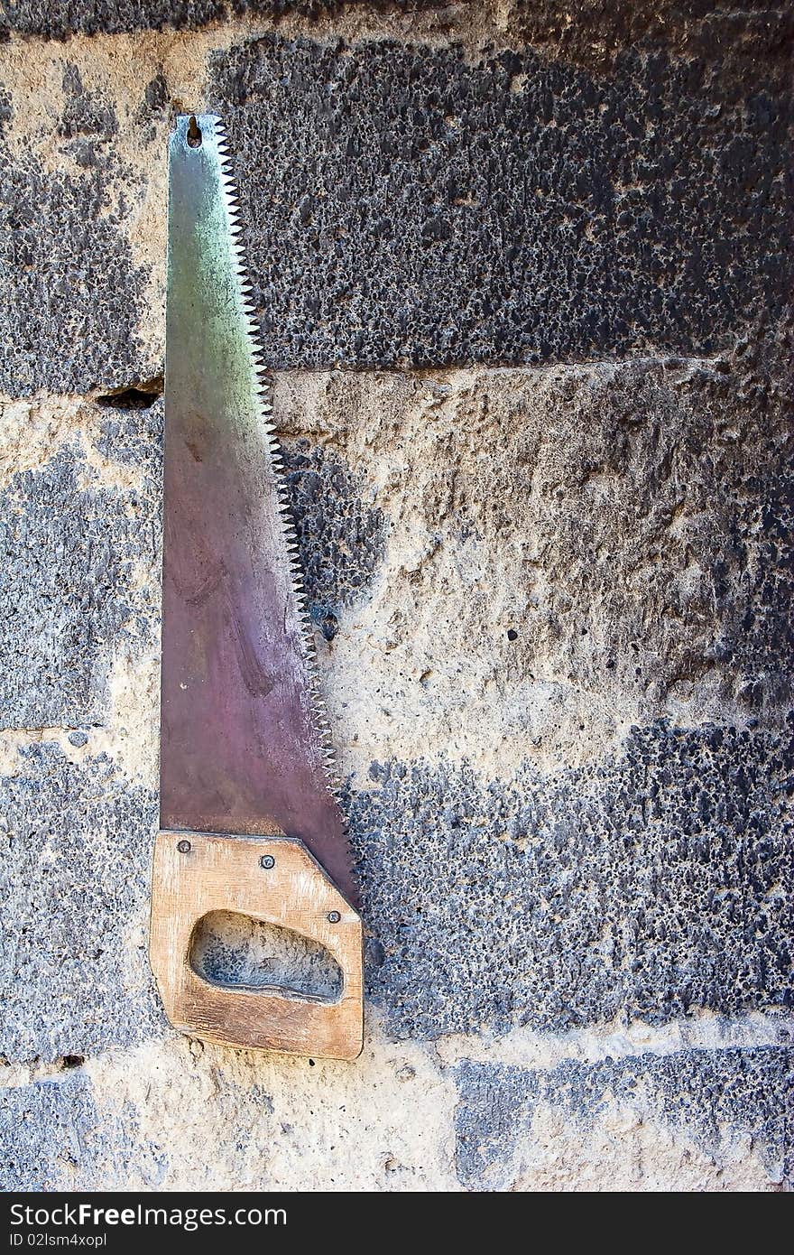 Aging rusty hacksaw on wall. Aging rusty hacksaw on wall