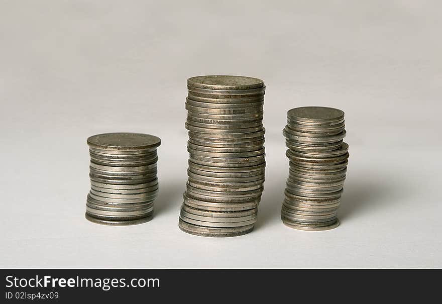 Three columns of the coins on white background