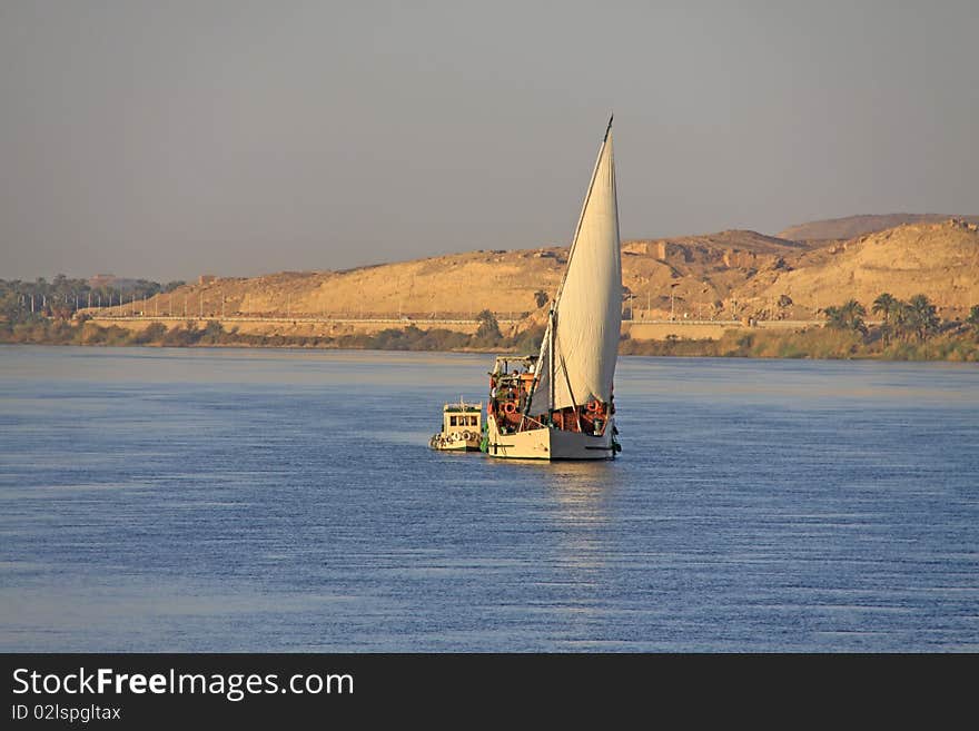 Sailing ship with a small motor boat on the Nile in Egypt