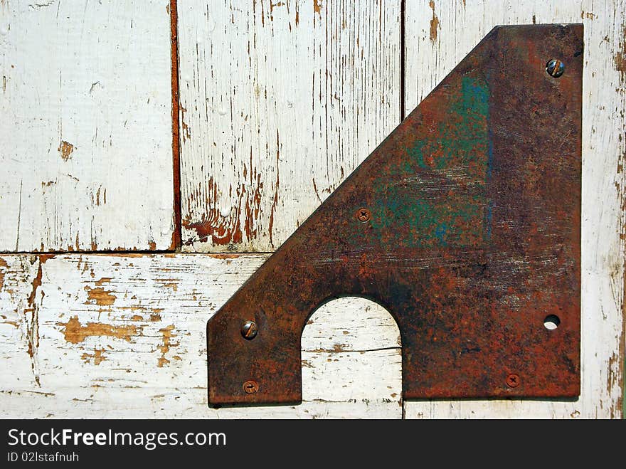 Old door corner armed with iron strap