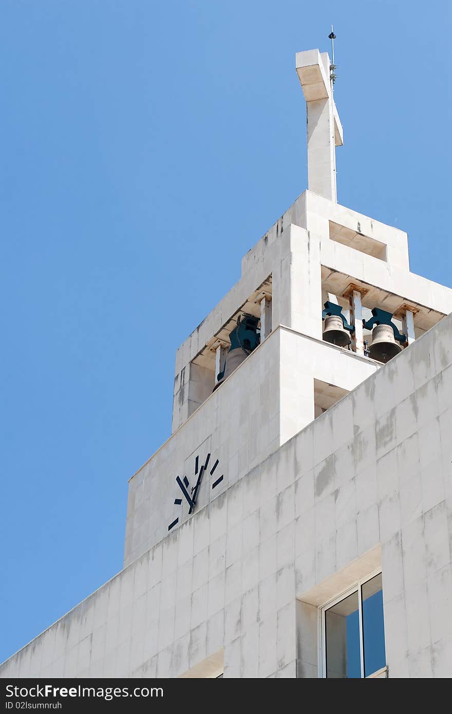 Ground view of a church tower, bells and clock. Ground view of a church tower, bells and clock