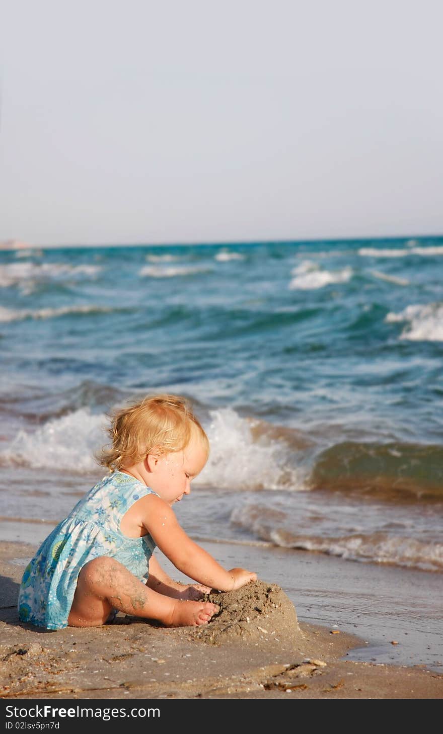 Toddler girl playing on beach