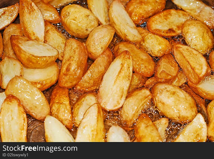 Roasted new potatoes background detail. Roasted new potatoes background detail