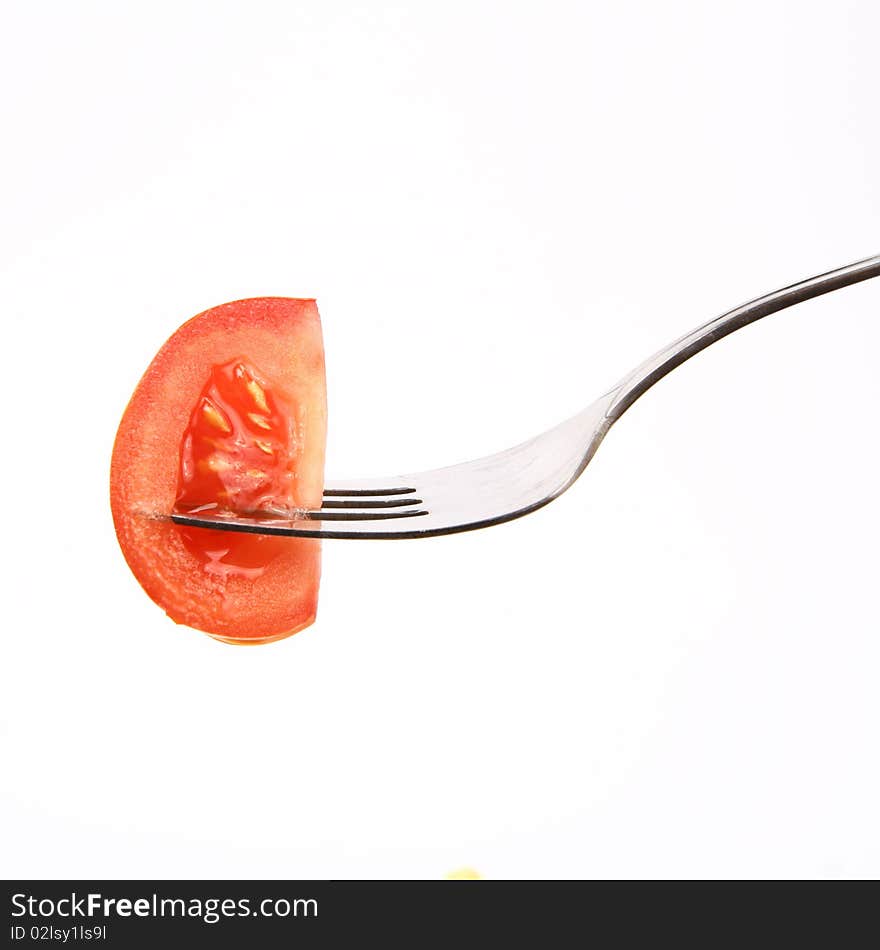 Piece of tomato on fork on white background