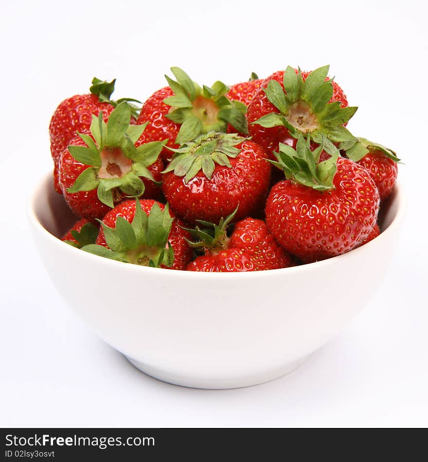 Strawberries in a bowl on white background