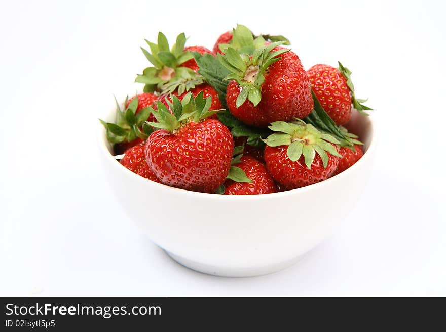 Strawberries in a bowl on white background