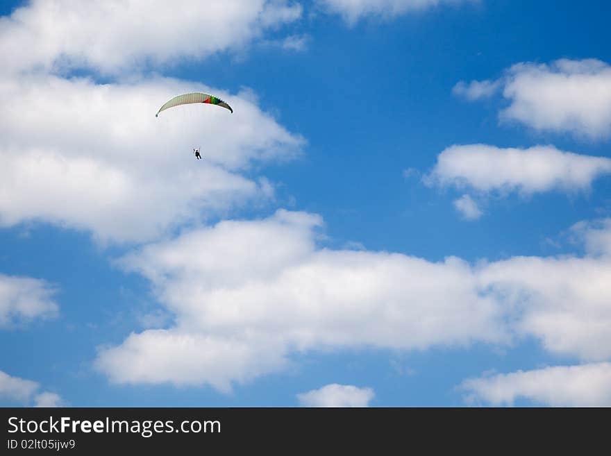 Paraglider flying over the field