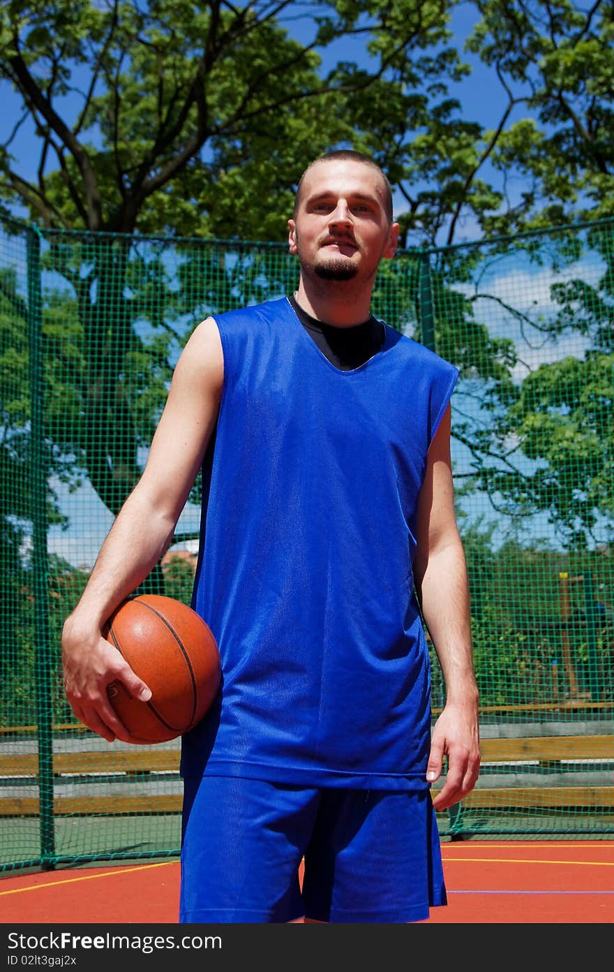 Young basketball player with ball on the sportground. Young basketball player with ball on the sportground