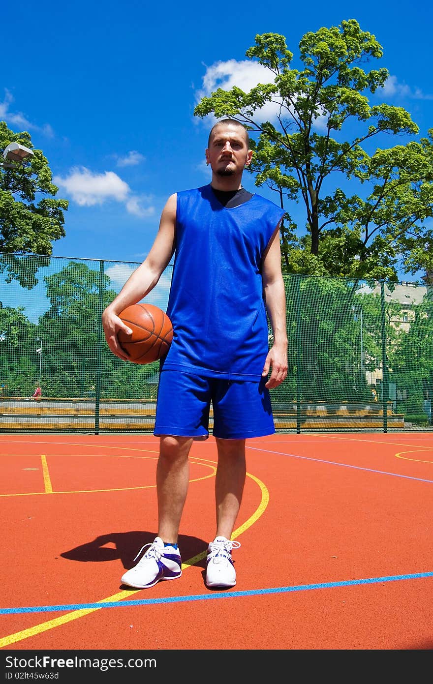 Young basketball player with ball on the sportground. Young basketball player with ball on the sportground