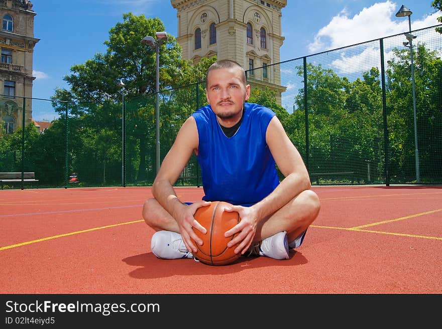 Young basketball player with ball on the sportground - wide picture. Young basketball player with ball on the sportground - wide picture