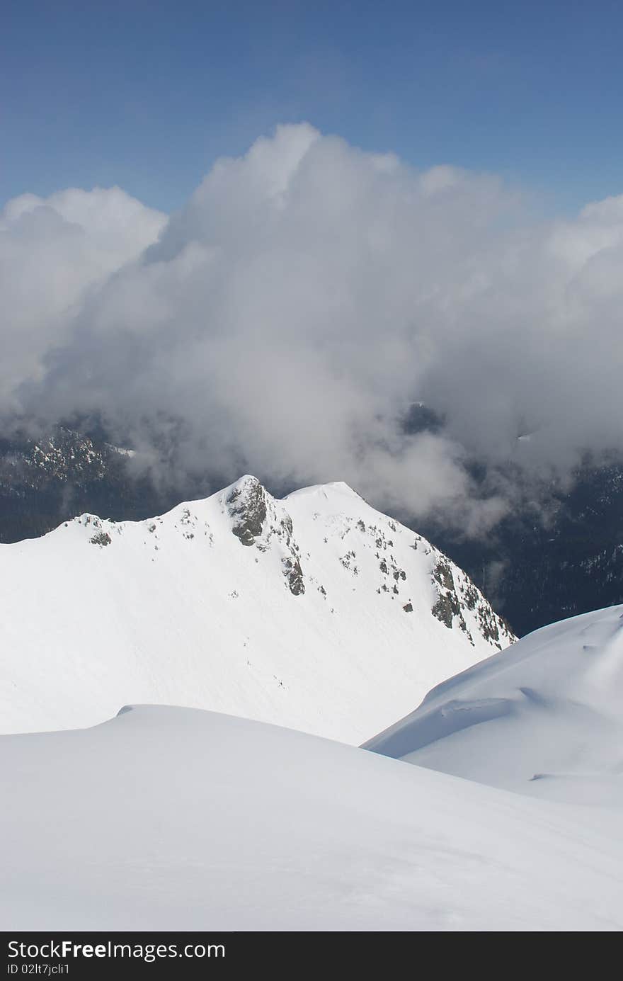 Mountain winter slope in clouds.