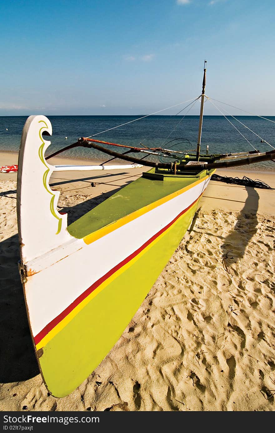 Green and White Wooden Outrigger Boat