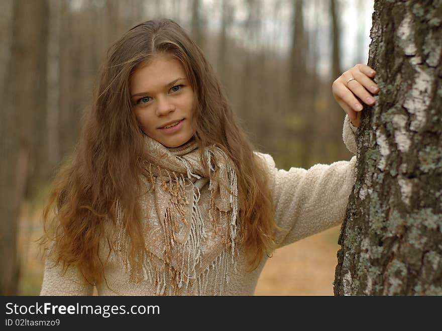 Girl leaning against a birch tree. Girl leaning against a birch tree