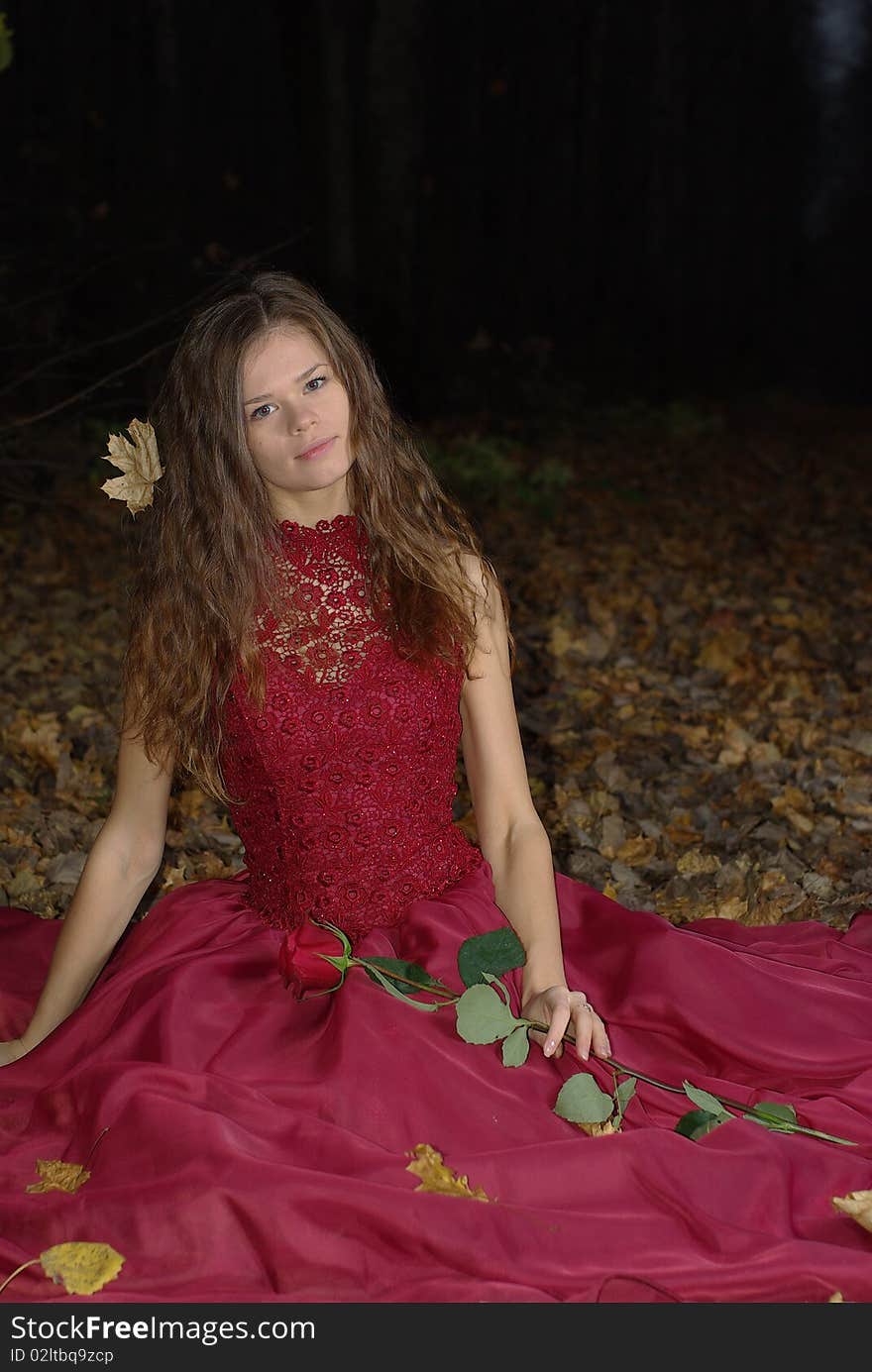 Girl in a red dress with a maple leaf in her hair. Girl in a red dress with a maple leaf in her hair