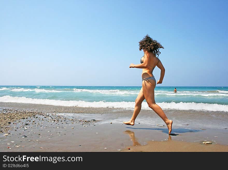 Running girl on the beach.