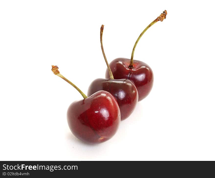 Three dark red cherry isolated in white. Three dark red cherry isolated in white