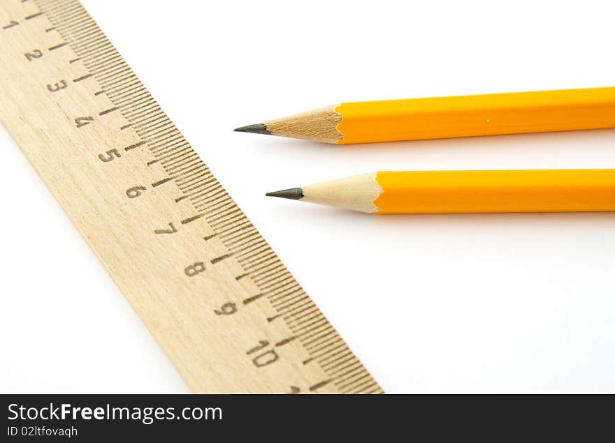 Ruler and two pencils isolated on white background