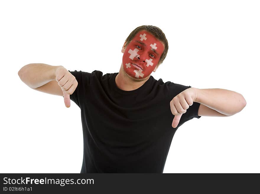 Man with swiss flag painted on his face showing two thumbs down, isolated on white background. Man with swiss flag painted on his face showing two thumbs down, isolated on white background