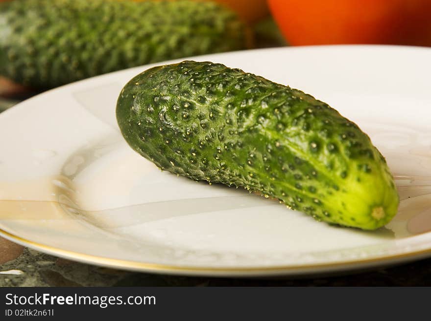 Green cucumber on a plate