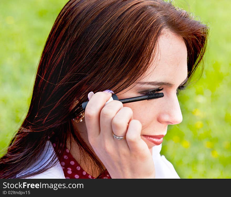 Cute lady performing makeup