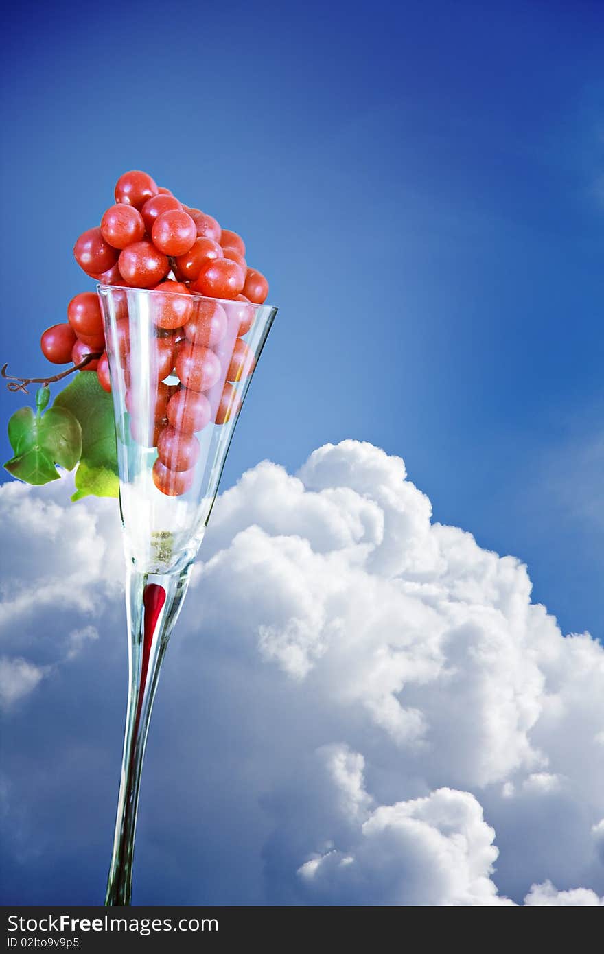 Grapes in an elegant glass against blue sky