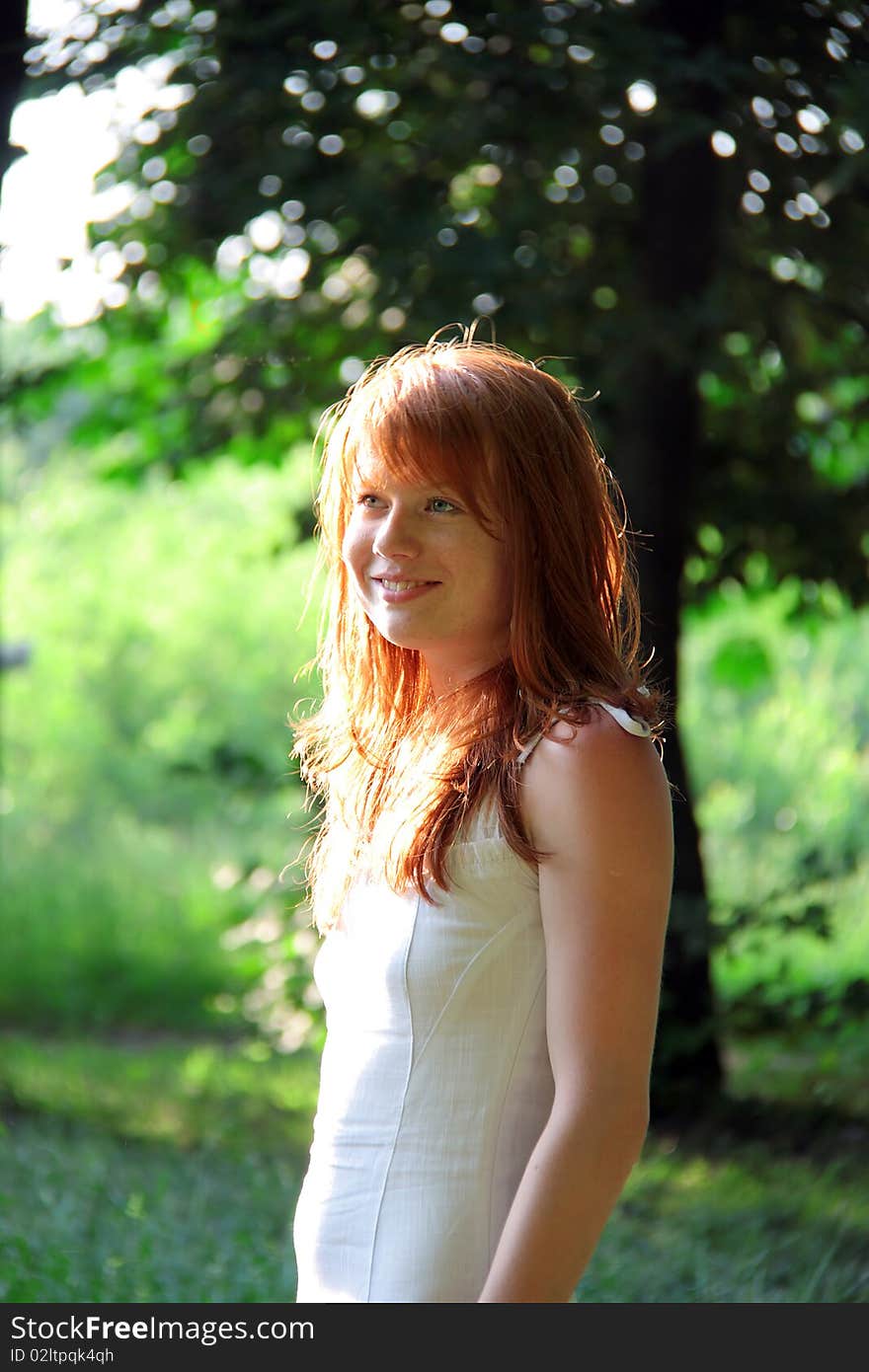 Redhead girl smiles on a summer evening. Redhead girl smiles on a summer evening