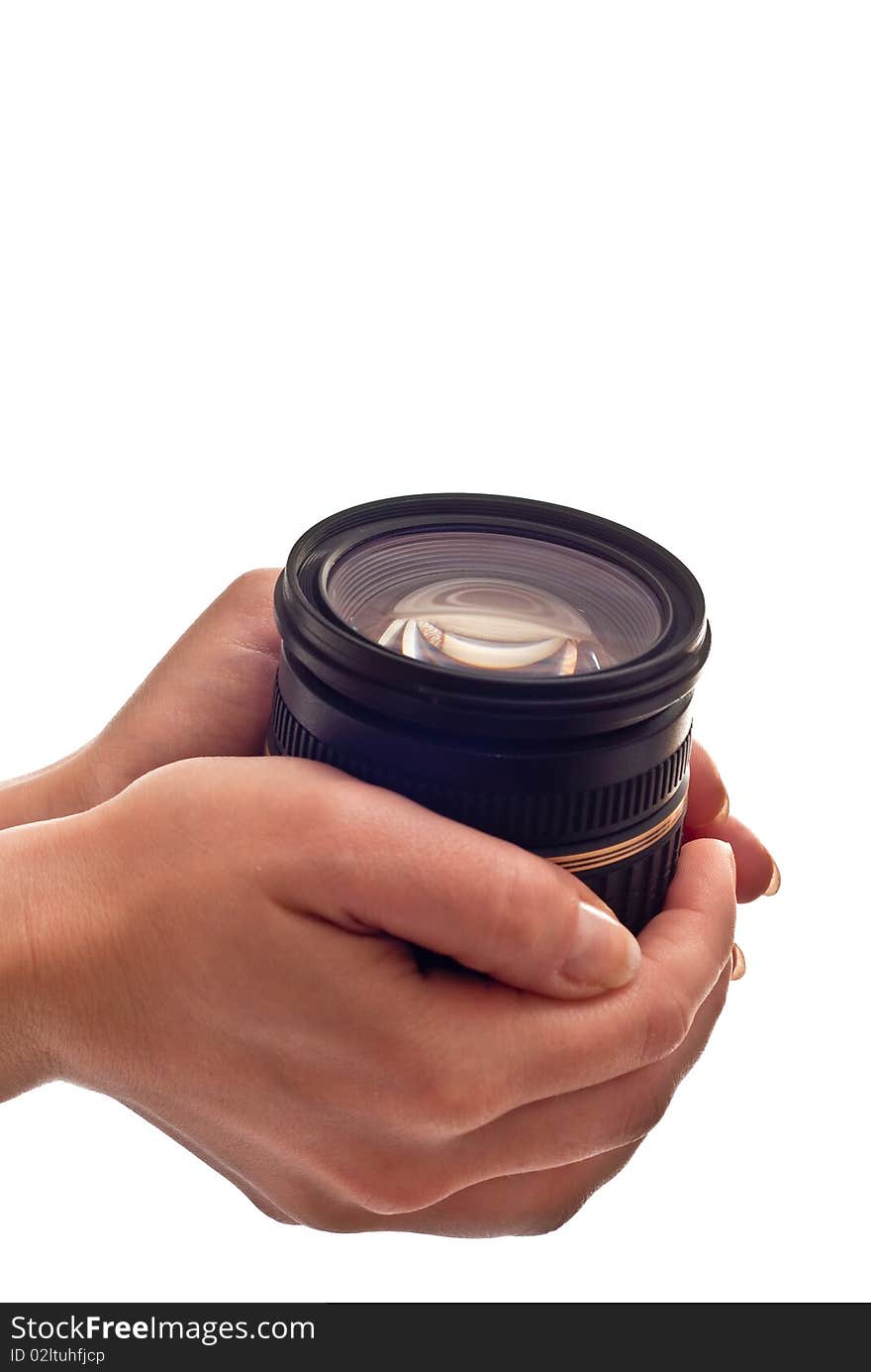 Black photo lens in woman's hands. Isolated on white. Black photo lens in woman's hands. Isolated on white