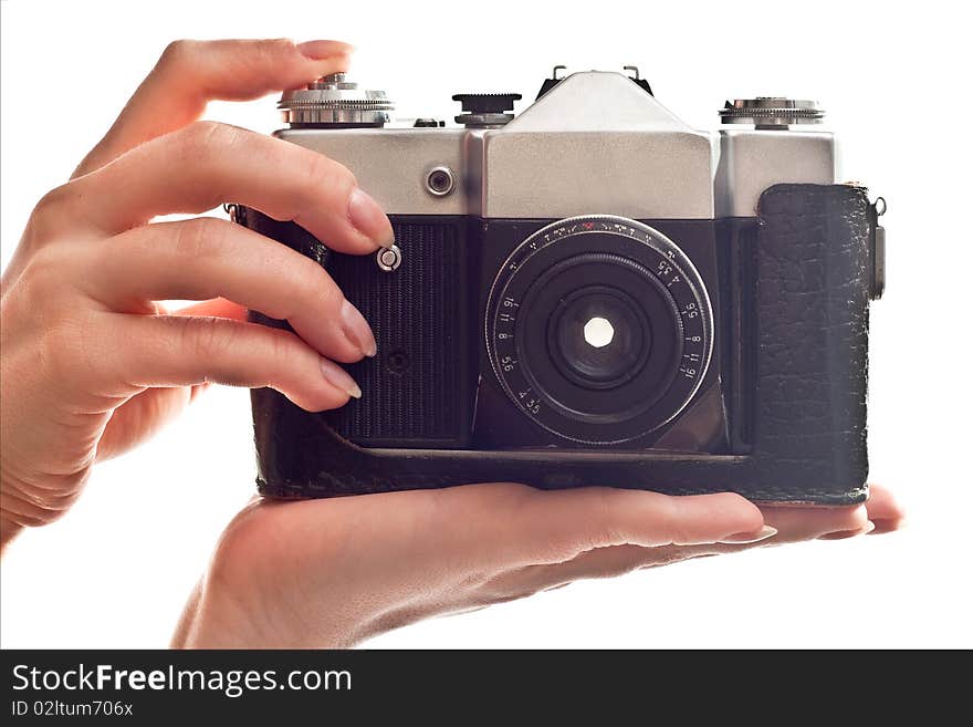 Black old camera in woman's hand. Isolated on white