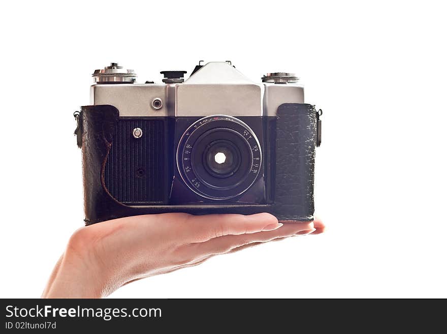 Black old camera in woman's hand. Isolated on white background