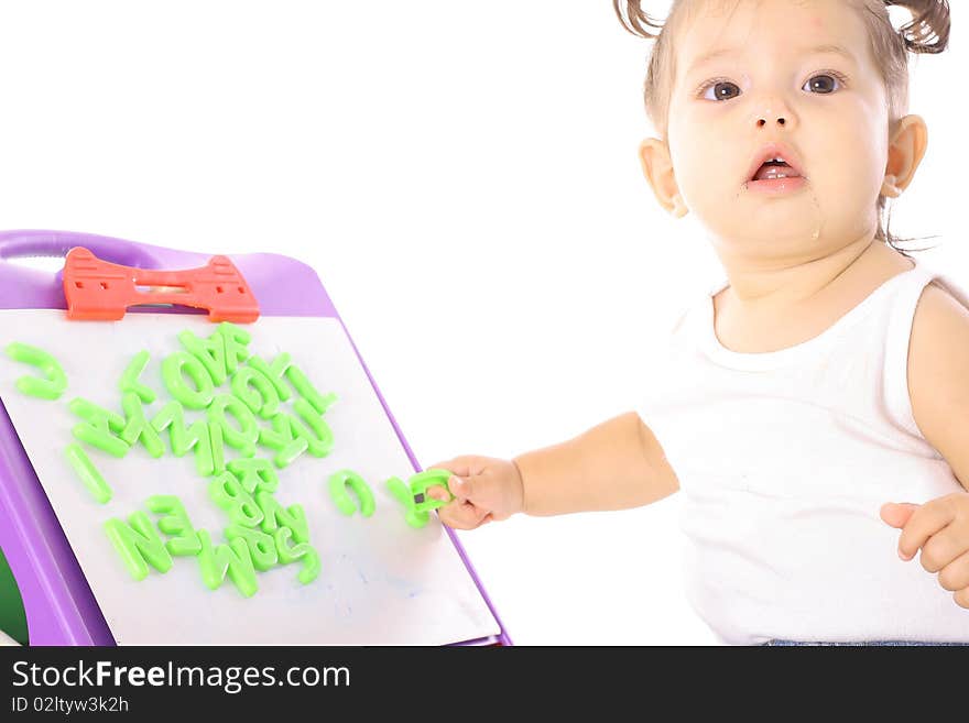 Cute little girl playing with ABC