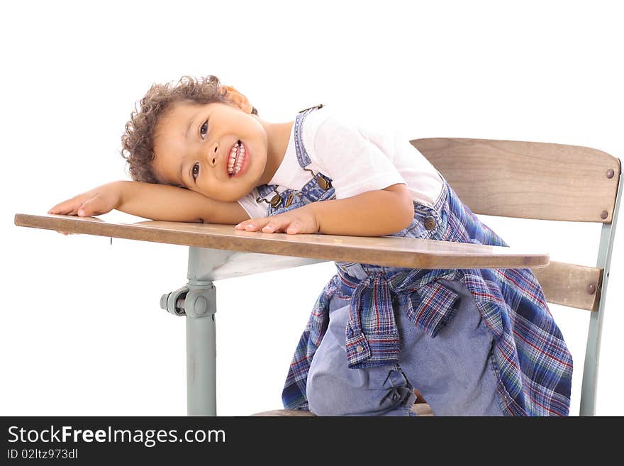 Shot of an adorable little boy sitting in a desk