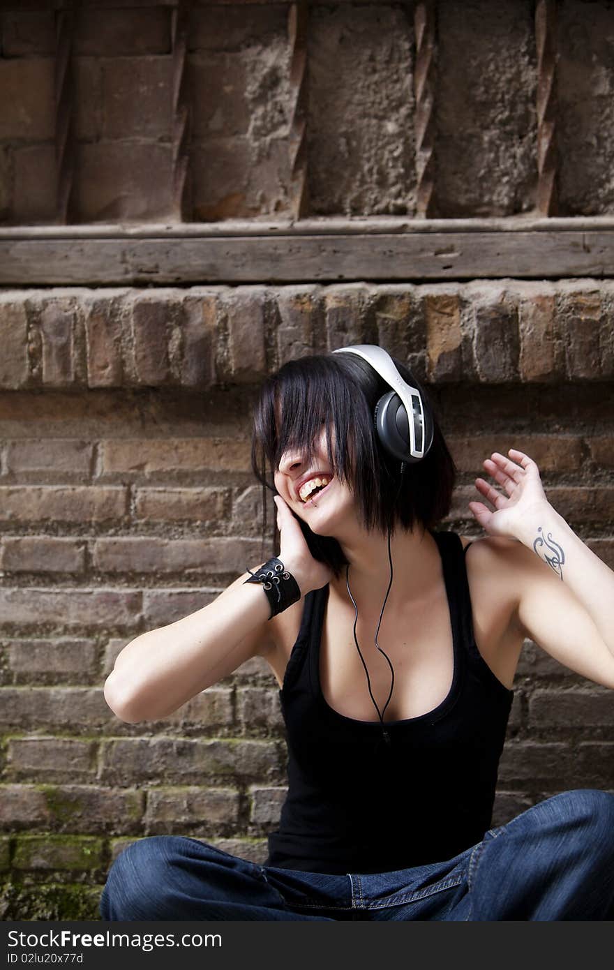 Young beautiful urban girl enjoying music. Young beautiful urban girl enjoying music