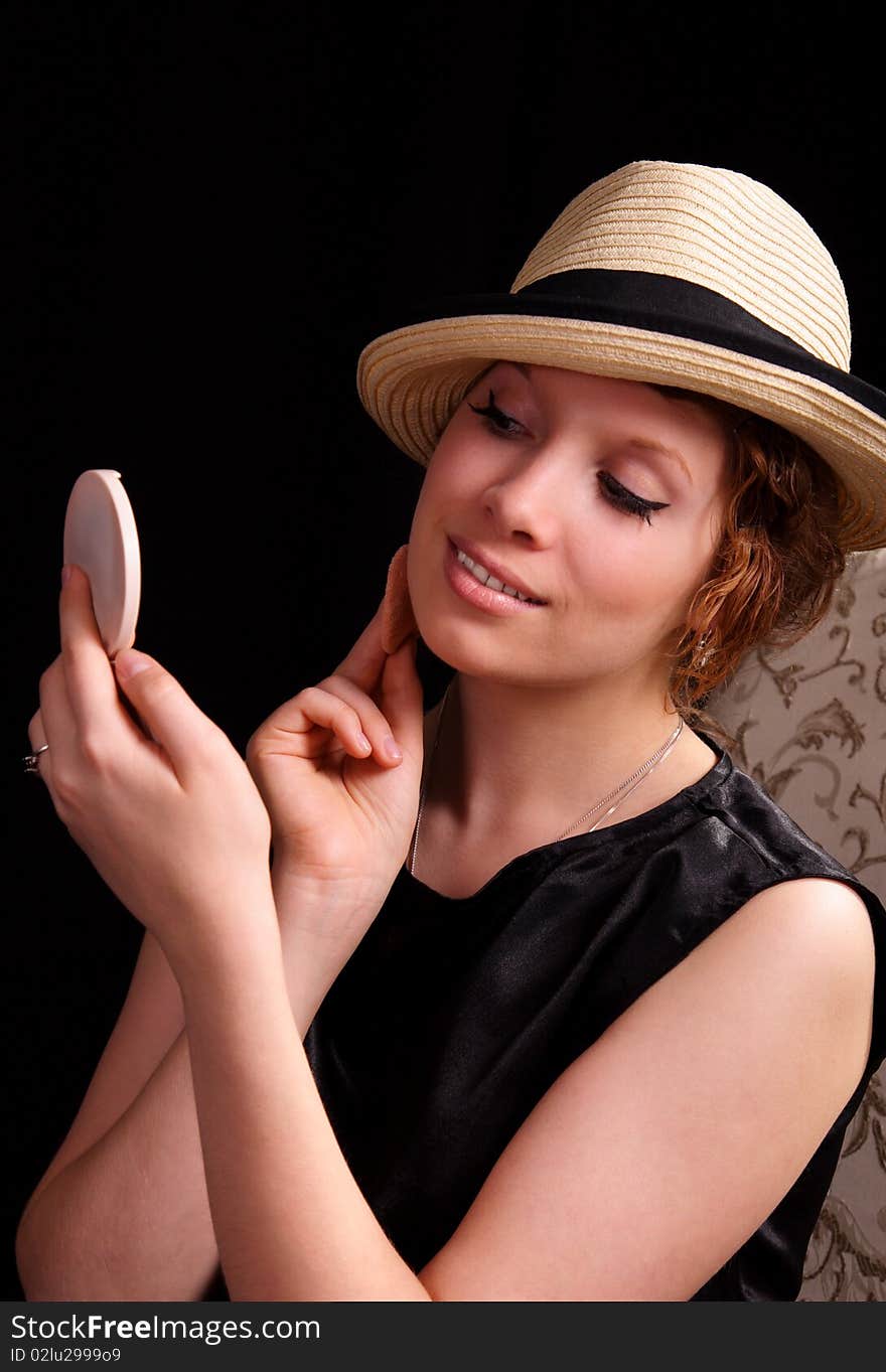 Beautiful young woman applying her makeup. Beautiful young woman applying her makeup