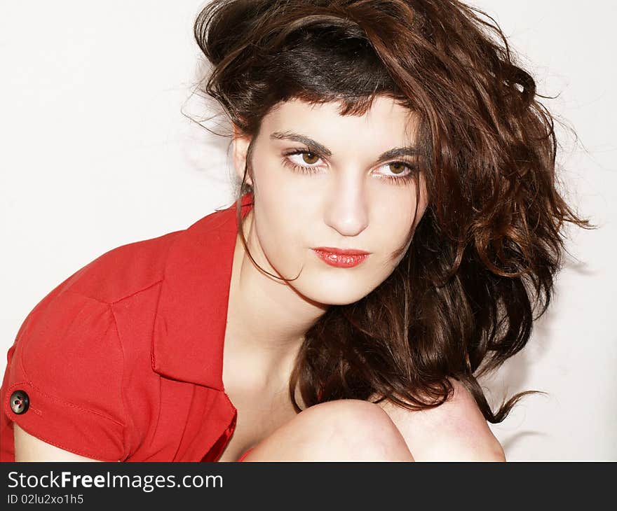 Young woman in red dress posing