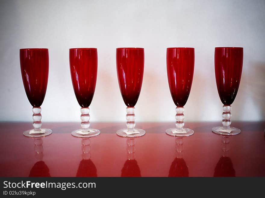 Red glass cups stand on the table. Red glass cups stand on the table