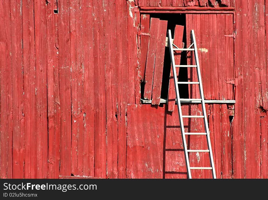 Ladder on a red barn