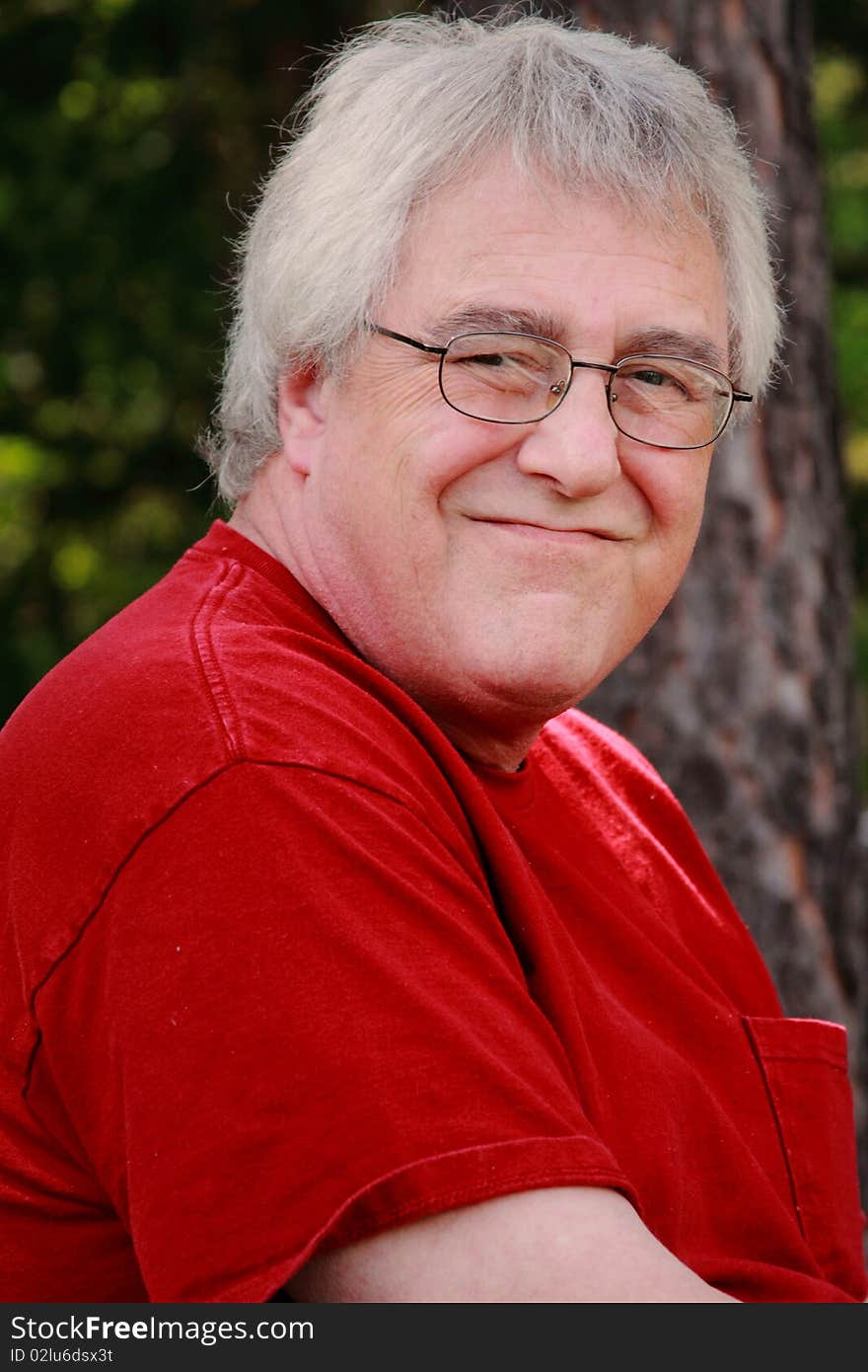 Baby boomer man smiling with gray hair and glasses